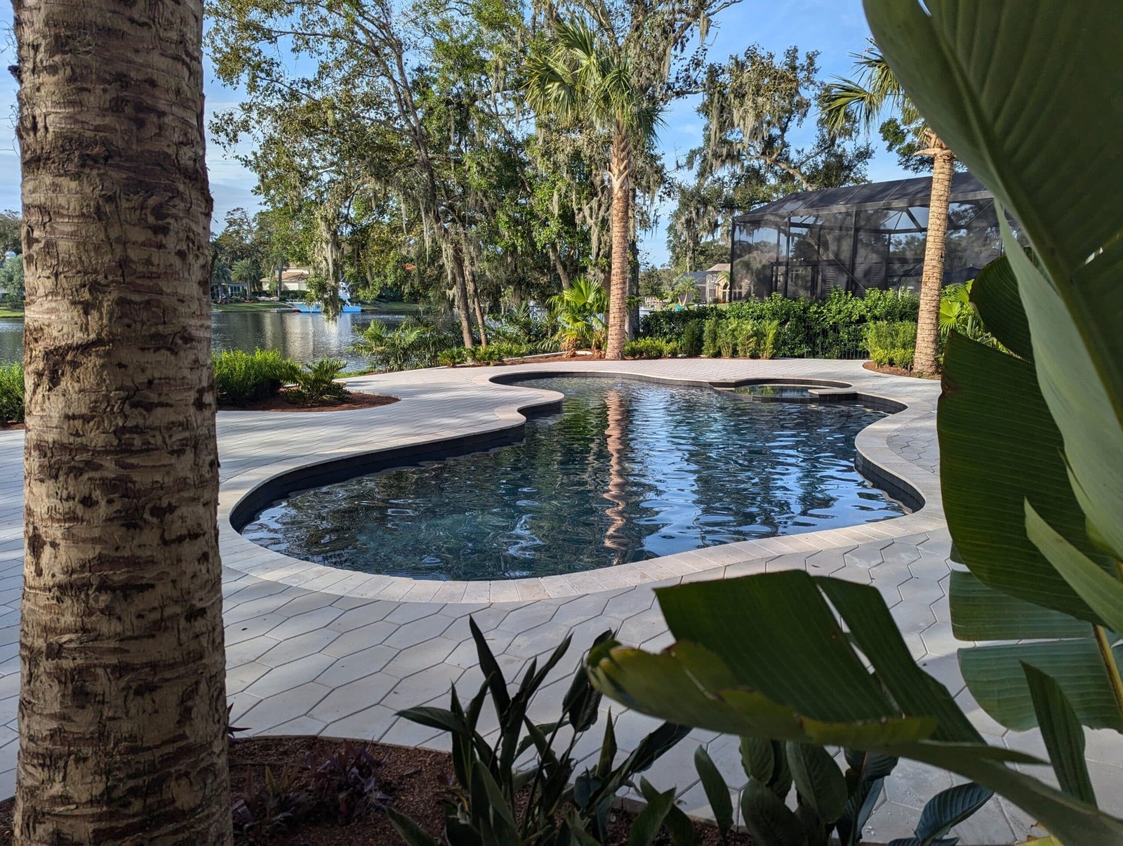 Custom pool renovation in Jacksonville Florida with updated tile, resurfacing, and modern decking by Southern Elegance Pools
