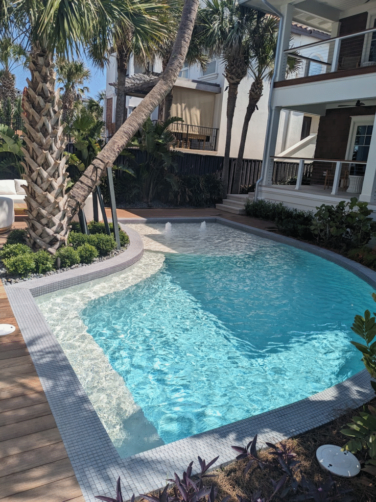 Pool with curved coping and waterline tiled entirely in small-format glass mosaic